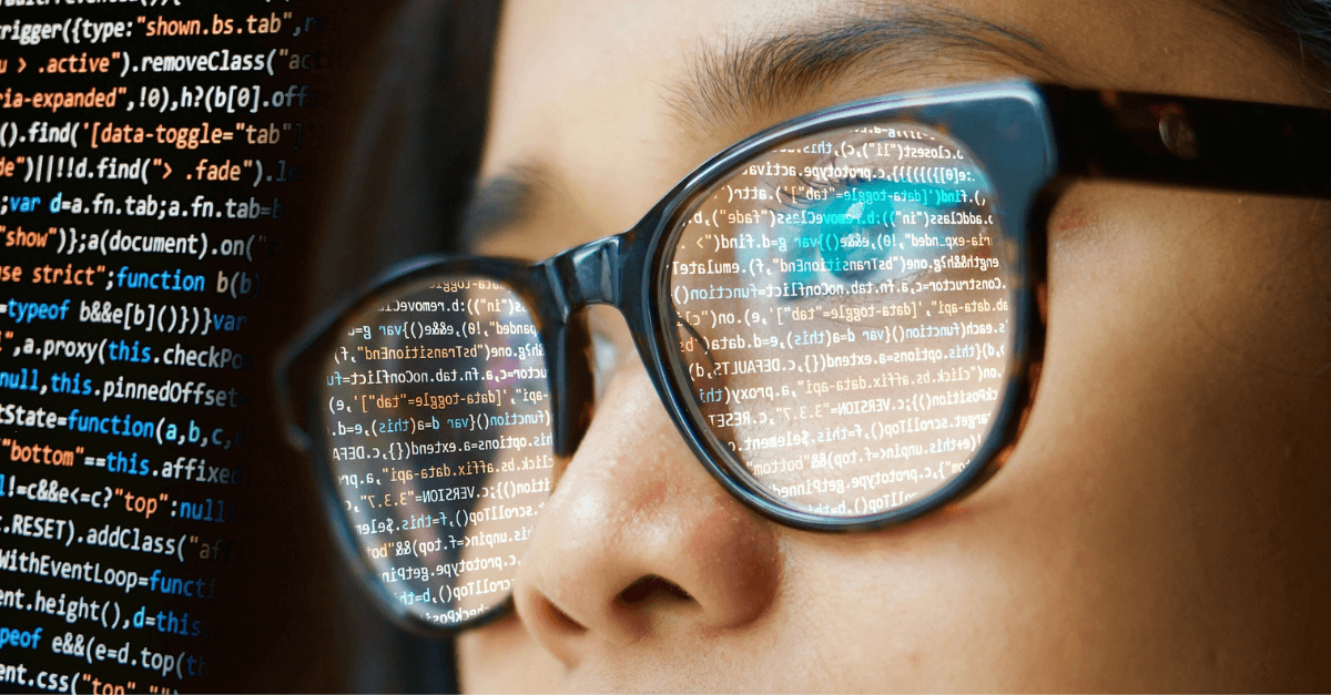 Woman in glasses looking on code lines
