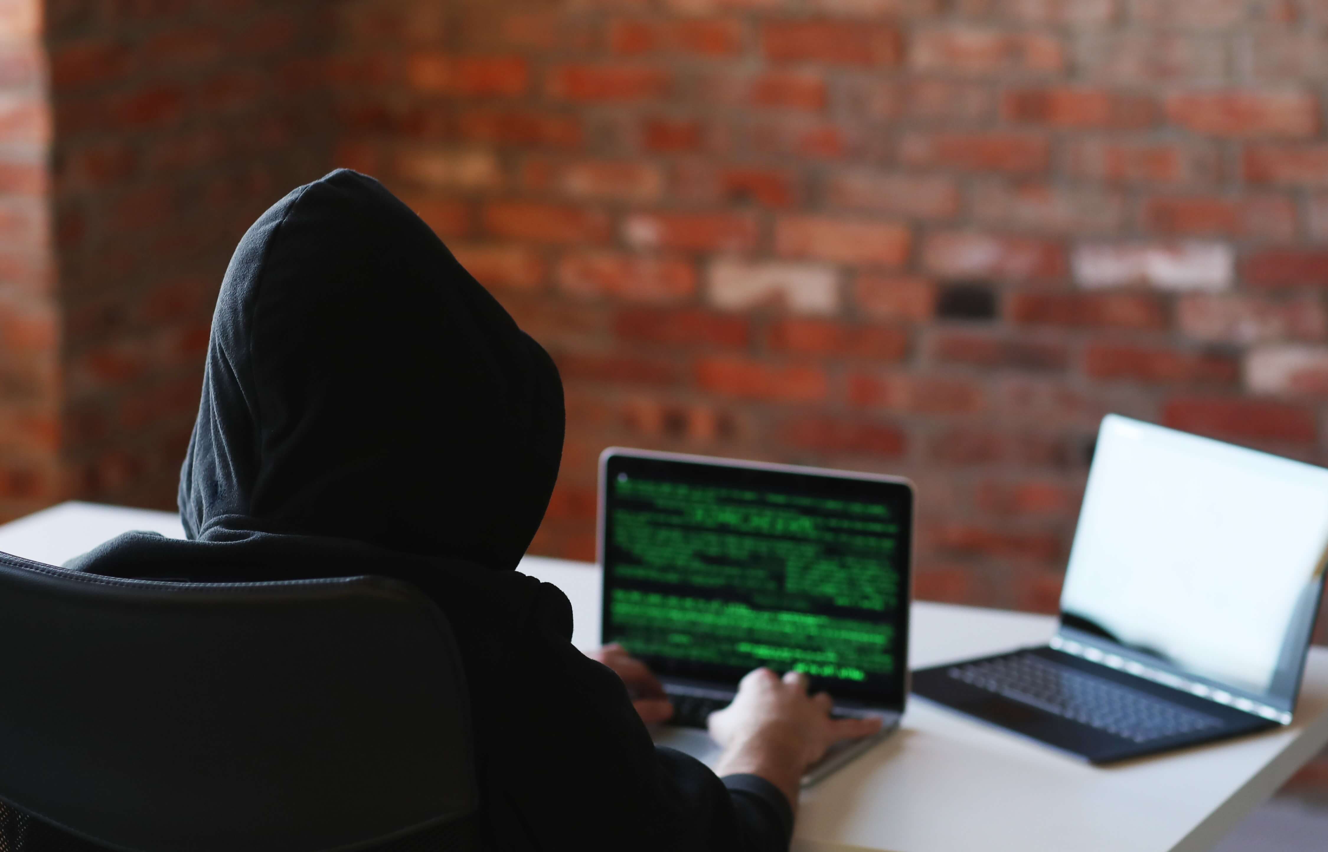 Man in hoodie with laptop